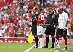 Arsenal substitute Theo Walcott waits to come on