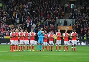 The Arsenal team take part in a minutes applause for a former Hull youth team player