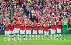 Arsenal V Wigan Athletic - FA Cup Semi Final 2014 Prints: The Arsenal team during the Minutes Applause for the victims of the Hillsborough Disaster