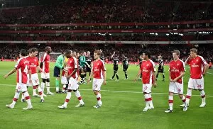 The Arsenal team walk out onto the pitch before the match