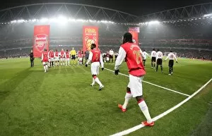 The Arsenal team walk onto the pitch before the match