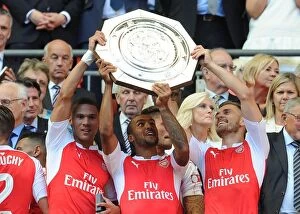 Arsenal v Chelsea - Community Shield 2015-16 Collection: Arsenal Triumph in Community Shield: Gibbs, Walcott, Ramsey Lift the Trophy against Chelsea