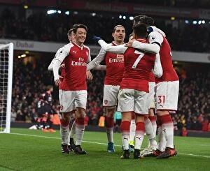 Arsenal v Huddersfield Town 2017-18 Collection: Arsenal Triumph: Ozil, Sanchez, Bellerin Celebrate Goals Against Huddersfield Town