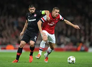 Arsenal V Olympiacos 2012-13 Prints: Arsenal Triumphs Over Olympiacos: Lukas Podolski Scores in a 3-1 UEFA Champions League Victory