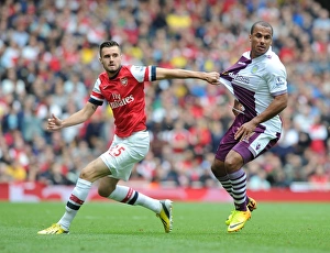 Arsenal V Aston Villa 2013-14 Prints: Arsenal vs. Aston Villa: Jenkinson vs. Agbonlahor in Intense Battle at Emirates Stadium