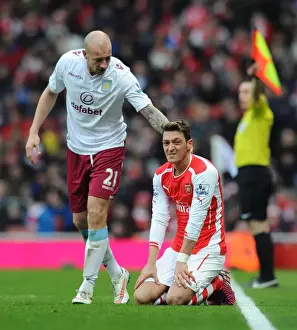 Arsenal V Aston Villa 2014-15 Prints: Arsenal vs Aston Villa: Mesut Ozil Fouled by Alan Hutton during the 2014-15 Premier League Match