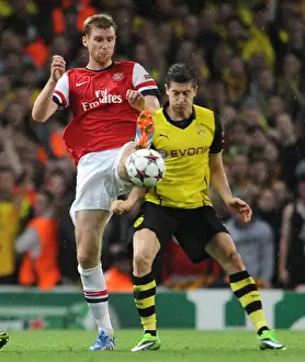 Arsenal V Borussia Dortmund 2013-14 Prints: Arsenal vs Borussia Dortmund: Mertesacker vs Lewandowski - UEFA Champions League Showdown
