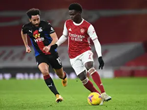 Arsenal vs Crystal Palace: Bukayo Saka in Action at Emirates Stadium Amidst Empty Seats (2020-21)