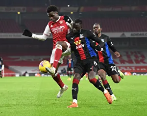 Arsenal vs. Crystal Palace: Bukayo Saka vs. Cheikhou Kouyate in Premier League Clash Amidst Empty Emirates Stadium
