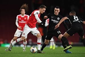 Images Dated 29th November 2019: Arsenal vs Eintracht Frankfurt: Mesut Ozil Clashes with Filip Kostic in Europa League Showdown