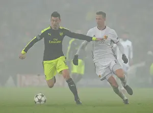 FC Basel V Arsenal 2016-17 Prints: Arsenal vs. FC Basel: Laurent Koscielny Faces Off Against Marc Janko in 2016-17 UEFA Champions League Clash