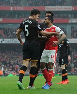Images Dated 11th February 2017: Arsenal vs Hull City: Walcott vs Maguire - A Fierce On-Field Showdown