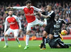 Images Dated 14th February 2016: Arsenal vs Leicester City: A Battle between Ozil and Simpson (February 14, 2016)