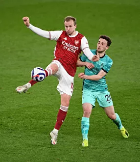 Images Dated 3rd April 2021: Arsenal vs. Liverpool: Holding Clears Under Pressure in Intense Premier League Clash