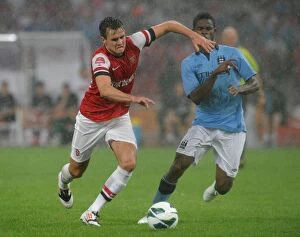 Images Dated 27th July 2012: Arsenal vs Manchester City: Jenkinson Holds Off Razak in Beijing Friendly