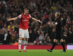 Images Dated 29th March 2014: Arsenal vs Manchester City: Per Mertesacker and Referee Mike Dean in Intense Action