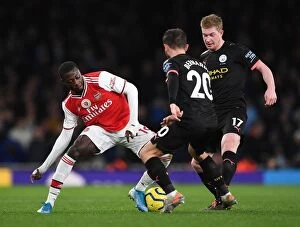 Images Dated 16th December 2019: Arsenal vs Manchester City: Pepe Takes on De Bruyne and Silva in Premier League Clash