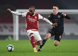 Arsenal v Manchester City - Carabao Cup 2020-21 Collection: Arsenal vs Manchester City Rivalry: Lacazette vs Foden - Emirates Showdown in Empty Carabao Cup