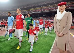Images Dated 27th July 2012: Arsenal vs Manchester City: Thomas Vermaelen Leads Arsenal in Beijing Friendly