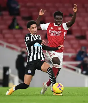 Arsenal vs Newcastle United: Bukayo Saka Tangles with Jamal Lewis in Empty Emirates Stadium