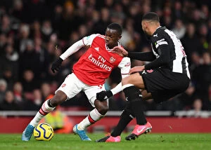 Arsenal v Newcastle United 2019-20 Collection: Arsenal vs Newcastle United: Eddie Nketiah Clashes with Jamaal Lascelles in Premier League Showdown