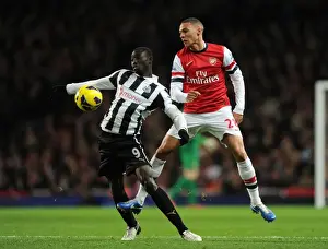 Arsenal V Newcastle United 2012-13 Prints: Arsenal vs Newcastle United: Kieran Gibbs vs Papiss Cisse - Intense Battle in the Premier League