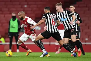 Arsenal V Newcastle United 2020-21 Prints: Arsenal vs Newcastle United: Lacazette Faces Off Against Lascelles and Krafth in Empty Emirates Stadium