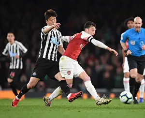 Arsenal V Newcastle United 2018-19 Prints: Arsenal vs Newcastle United: Mesut Ozil Faces Off Against Ki Sung-Yueng in Premier League Clash