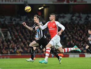 Arsenal v Newcastle United 2014/15 Collection: Arsenal vs Newcastle United: Olivier Giroud Faces Mike Williamson in Premier League Clash