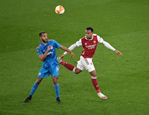 Arsenal vs Olympiacos: Gabriel Magalhaes Heads Away Under Pressure in Emirates Stadium - UEFA Europa League Round of 16 (Behind Closed Doors)