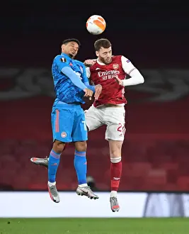 Arsenal vs. Olympiacos: Calum Chambers Heads the Ball in Empty Emirates Stadium - UEFA Europa League Round of 16