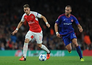 Arsenal V Olympiacos 2015/16 Prints: Arsenal vs. Olympiacos: Ozil vs. Kasami Clash in the 2015/16 UEFA Champions League