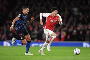Arsenal vs Sevilla: Battle in Group B - Arsenal's Tomiyasu Outruns Lamela in the UEFA Champions League 2023/24