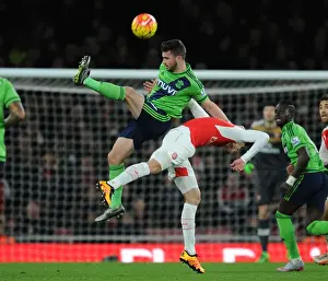 Arsenal V Southampton 2015-16 Prints: Arsenal vs. Southampton: A Battle Between Gabriel and Long at the Emirates Stadium