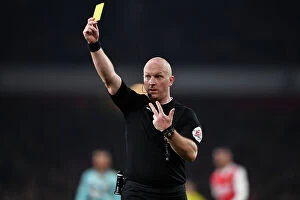 Images Dated 21st April 2023: Arsenal vs. Southampton: Simon Hooper Shows Yellow Card in Intense Premier League Clash (2022-23)