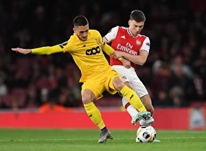 Arsenal v Standard Liege 2019-20 Collection: Arsenal vs Standard Liege: Kieran Tierney Clashes with Aleksandar Beljevic in Europa League Showdown