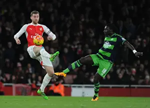 Arsenal vs Swansea Clash: Mertesacker vs Gomis Battle at Emirates Stadium