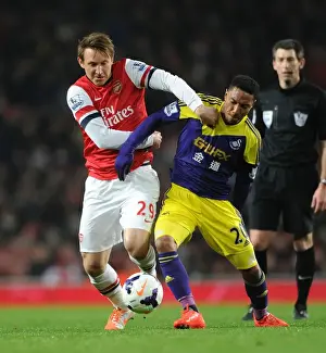 Arsenal V Swansea City 2013-14 Prints: Arsenal vs Swansea: Kallstrom vs De Guzman - Intense Battle in the Premier League