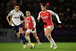 Arsenal Women v Tottenham Hotspur Women - Conti Cup 2023-24 Collection: Arsenal vs. Tottenham Women's Clash in FA WSL Cup: Kyra Cooney-Cross Fights Past Rosella Ayane