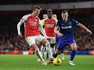 Images Dated 28th December 2023: Arsenal vs. West Ham: Martin Odegaard Clashes with James Ward-Prowse in Premier League Showdown