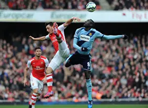 Arsenal V West Ham United 2014/15 Prints: Arsenal vs. West Ham United: Intense Clash between Ozil and Kouyate in the Premier League