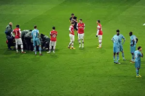 Arsenal and West Ham players wait for Daniel Potts (West Ham) to be treated for an injury