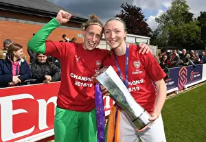 Arsenal Women Celebrate Historic WSL Title Win with Captains Sari van Veenendaal and Louise Quinn Holding the Trophy