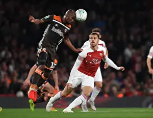 Arsenal V Brentford - Carabao Cup 2018-19 Prints: Arsenal's Aaron Ramsey Clashes with Brentford's Kamohelo Mokotjo in Carabao Cup Showdown
