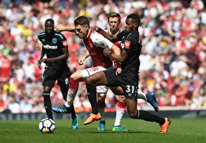 Arsenal's Aaron Ramsey Clashes with West Ham's Edimilson Fernandes in Premier League Showdown