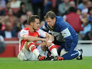Arsenal V Tottenham Hotspur 2014-15 Prints: Arsenal's Aaron Ramsey Consults Physio Colin Lewin During Arsenal v Tottenham Clash