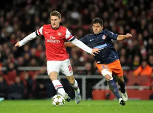 Arsenal V Montpellier 2012-13 Prints: Arsenal's Aaron Ramsey Faces Off Against Montpellier's Marco Estrada in 2012-13 Champions League Clash