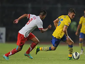 Indonesia Dream Team V Arsenal 2013-14 Prints: Arsenal's Aaron Ramsey Faces Off Against Raphael Maitimo of Indonesia Dream Team