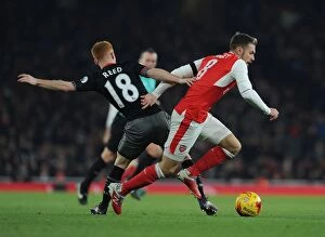 Arsenal v Southampton EFL Cup 2016-17 Collection: Arsenal's Aaron Ramsey Faces Off Against Southampton's Harrison Reed in EFL Cup Clash