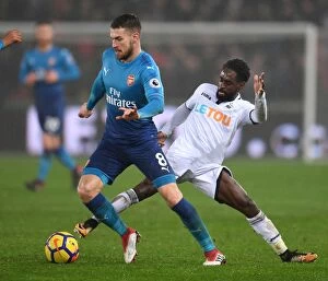 Swansea City v Arsenal 2017-18 Collection: Arsenal's Aaron Ramsey Faces Off Against Swansea's Nathan Dyer in Premier League Clash